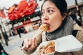 Lady tourist trying tasty famous takoyaki Royalty Free Stock Photo