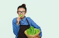 Asian girl eating green vegetable Happy mood. Royalty Free Stock Photo