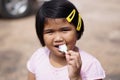 Asian girl eating ice cream to relieve heat Royalty Free Stock Photo