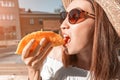 Asian girl eating taco outside. Mexican fastfood cuisine. Tasty and spicy snack in park Royalty Free Stock Photo