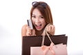 Asian girl enjoy shopping with credit card and shopping bag isolated on white background Royalty Free Stock Photo