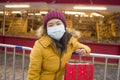 Asian girl enjoying Christmas shopping during covid19 - young happy and beautiful Korean woman with mask holding red shopping bag Royalty Free Stock Photo