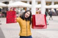 Asian girl enjoying Christmas shopping - young happy and beautiful Chinese woman holding red shopping bag buying presents at Royalty Free Stock Photo