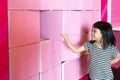 Asian girl enjoys flipping pink partition boards.