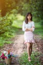 Asian girl with flower in the garden