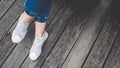 Asian girl foot and legs seen from above selfie with blue jeans preparing to travel. Royalty Free Stock Photo