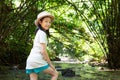 Asian girl in forest at stream,cute little girl studying and lea