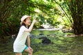 Asian girl in forest at stream,cute little girl studying and lea