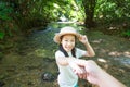 Asian girl in forest at stream,cute little girl studying and lea