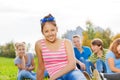 Asian girl and friends sitting together in park Royalty Free Stock Photo