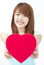Asian girl giving red heart gift