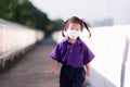 Asian girl go to school in morning. She stands on overpass.