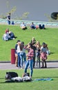 Asian girl with group of youngsters on Museum Square, Amsterdam, Netherlands