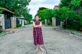 Asian girl happily walking and relaxing in front of the house. with a smiling face in the morning Royalty Free Stock Photo