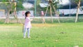 Asian girl is having fun in battle by using sheath of Koon tree to make sword knife. Child play role-playing. Royalty Free Stock Photo