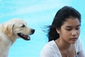 Asian girl with her pet dog (focus is on the girl). Royalty Free Stock Photo