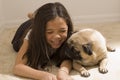 Asian Girl with Her Pet Pug Royalty Free Stock Photo