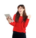 Asian girl holding tablet with pumping fist