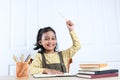 Asian Girl Holding Up Pencil Pointing While Doing Homework