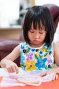 Asian girl home schooling sewing Royalty Free Stock Photo