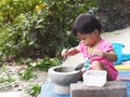 Asian girl kids play cooking with mortar