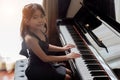 Asian girl kids playing piano have talent and practice for up skill Royalty Free Stock Photo