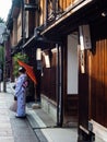 Kanazawa, Japan - September 28, 2015: Girl in kimono with red umbrella in Higashi Chaya old geisha district Royalty Free Stock Photo