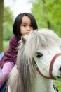 Asian girl on little horse