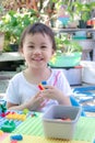 Asian girl, little toddler preschooler child playing creative colorful building blocks toy at home Royalty Free Stock Photo