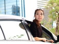 Asian girl looking at back of car Royalty Free Stock Photo