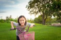 Asian girl looking at camera, smiling with a cute on bicycle in the outdoor park,child exercise in nature in the morning,healthy