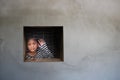 Asian girl looking out the window were imprisoned in a house , Human trafficking