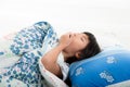 Asian girl lying under a blanket in the bed Royalty Free Stock Photo