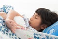 Asian girl lying under a blanket in the bed Royalty Free Stock Photo