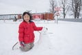 Asian girl making snowman, Switzerland, Europe