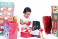 Asian girl opening Christmas presents Royalty Free Stock Photo