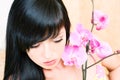 Asian girl with orchid Royalty Free Stock Photo