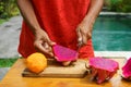 Asian girl peel red dragon fruit, Indonesia, Bali