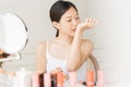 Asian girl with perfume, young woman applying perfume on her wrist and  smelling. Royalty Free Stock Photo