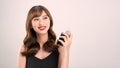 Asian girl with perfume, young woman applying perfume on her wrist and smelling Royalty Free Stock Photo