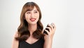 Asian girl with perfume, young woman applying perfume on her wrist and smelling Royalty Free Stock Photo