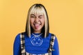 Asian girl with piercing showing her tongue and winking Royalty Free Stock Photo