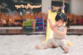 Asian girl play slider at outdoor playground, Cute child has accident abrasion wound trauma skin arm while playing slider, Royalty Free Stock Photo