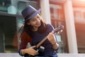 Asian girl play song with ukulele