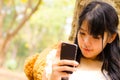 Asian girl playing cell phone Royalty Free Stock Photo
