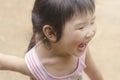 Asian girl playing on the playground .