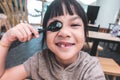 Asian girl playing with spoon on dinner table Royalty Free Stock Photo