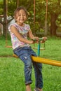 Asian girl playing on a teetertotter