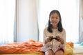 Asian girl playing video game on the bed Royalty Free Stock Photo