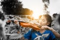 Asian girl playing violin in mist of sun flower field Royalty Free Stock Photo